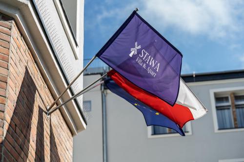 a flag hanging from the side of a building at Stawa Villa & Apart in Świnoujście