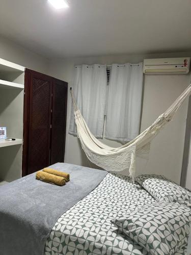 a hammock hanging over a bed in a bedroom at Pousada Nova Betânia in Mossoró