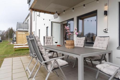 a gray table and chairs on a patio at Fully Equipped Home in Båstad with Cozy Patio in Båstad