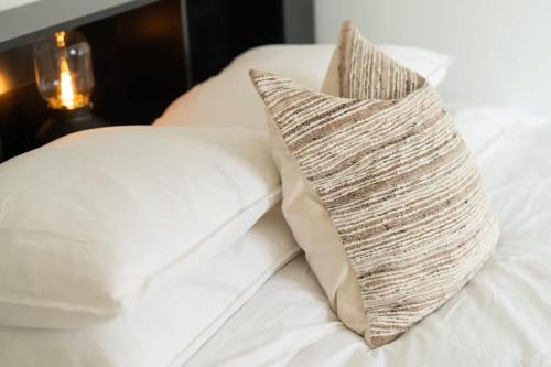 a white couch with a pillow on top of it at Fully Equipped Home in Båstad with Cozy Patio in Båstad