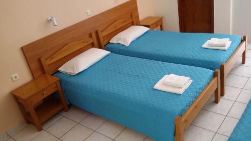 two beds in a room with two towels on them at Amaril in Platanes