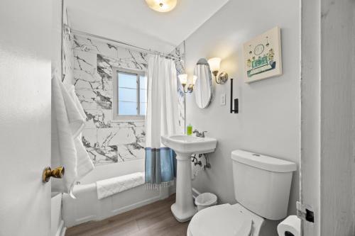 a bathroom with a toilet and a sink and a shower at Spacious 3BR Home 5 Mins to Airport and Downtown in Columbus
