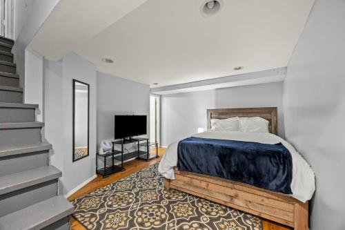 a bedroom with a bed and a flat screen tv at Spacious 3BR Home 5 Mins to Airport and Downtown in Columbus