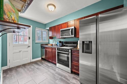 a kitchen with a stainless steel refrigerator and a microwave at 3BR Perfect for Work and Getaways in Columbus