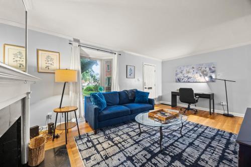 a living room with a blue couch and a piano at 3BR Perfect for Work and Getaways in Columbus