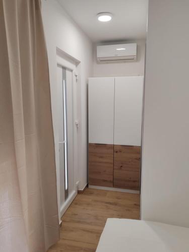 a room with a white cabinet and a mirror at Adriatica in Zadar