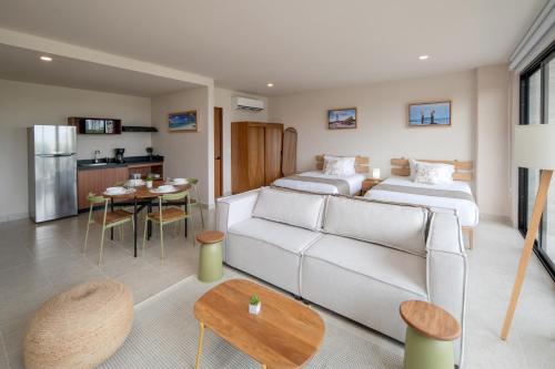 a living room with two beds and a couch at Everglades Suites in Cancún