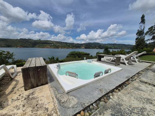 a swimming pool with a view of a lake at Casa el OLIVO in Club Las Anonimos