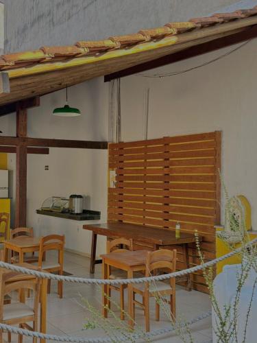 a dining room with a wooden table and chairs at Pousada Bons Ventos in Paraty