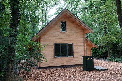 a small cabin in the woods with a window at Jesse's Log Cabin in Norg