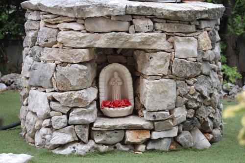 a model of a stone wall with a statue in it at Affittacamere La Madonnina in San Giovanni Rotondo