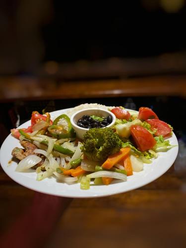 a plate of food with vegetables on a table at Las Arrieras Nature Reserve and Ecolodge in Horquetas