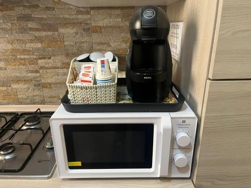 a coffee maker sitting on top of a microwave at La Petite Maison in Augusta