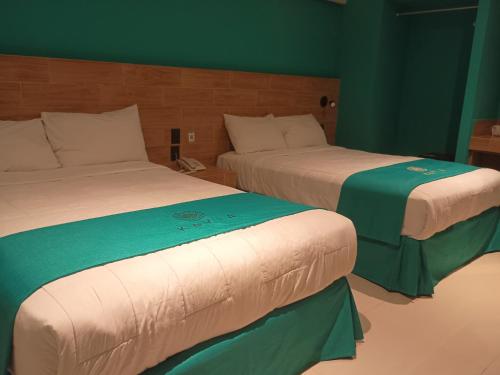 Ένα ή περισσότερα κρεβάτια σε δωμάτιο στο Hotel Kavia Mazatlán