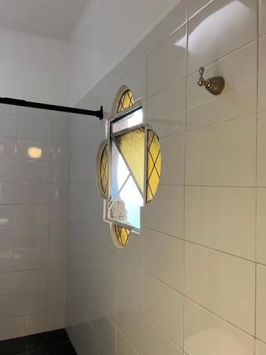 a bathroom with a light on the shower wall at Habitación Martinique Bed&Breakfast 4 personas en la Condesa in Mexico City