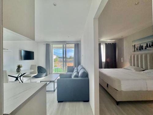 a bedroom and a living room with a bed and a couch at Family Apartments Stefan in Budva