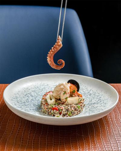 a white plate with food on a table at Radisson Blu Hotel, Cairo Heliopolis in Cairo