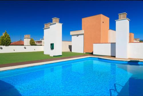 a swimming pool in front of a house at SOLIMAR 10 SALOU Solo FAMILIAS con Parking y piscina in Salou