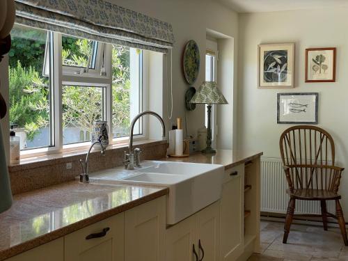 a kitchen with a sink and a window at Castle Reach Newport, Pembrokeshire in Newport Pembrokeshire