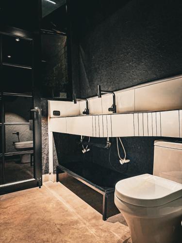 a bathroom with a toilet and a sink at Hostel43 in Estación El Salto