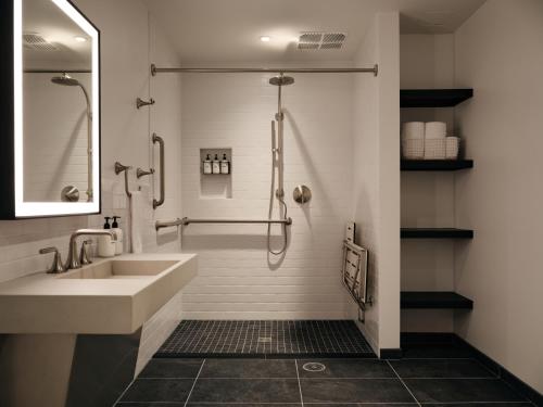 a bathroom with a sink and a shower at Mint House Washington DC - Downtown in Washington