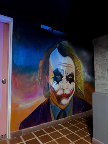 a large painting of a clown on a wall at Hostel43 in Estación El Salto