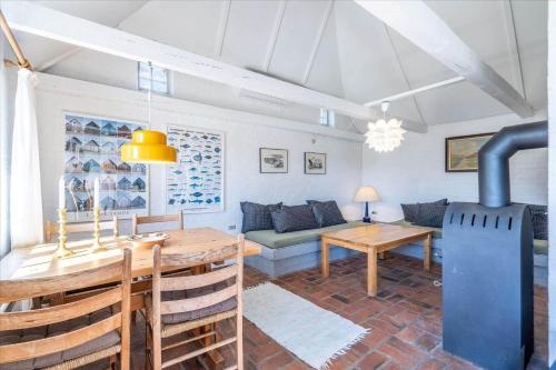 a living room with a table and a stove at 315-Hvide-Sande-Holmsland-Klitvej-115-vest in Hvide Sande