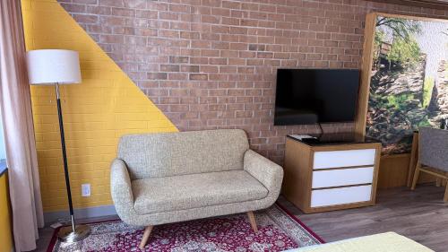 a living room with a chair and a tv at Split Rock Resort in Lake Harmony