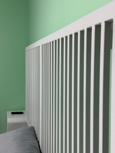 a bed with a striped headboard in a room at Hostel43 in Estación El Salto