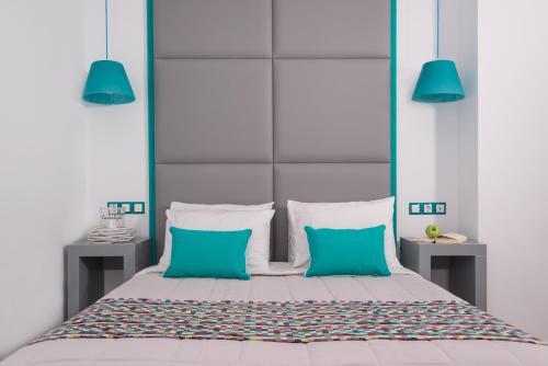 a bed with a white bedspread and pillows at Sweet Pop in Fira