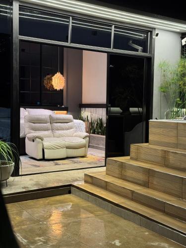 a living room with a couch and some stairs at Hostel43 in Estación El Salto