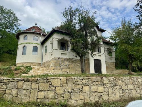 an old house on top of a stone wall at Conăcel între Vulcani 