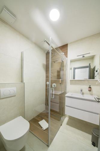 a bathroom with a shower and a toilet and a sink at Restoran Bosiljevo in Bosiljevo