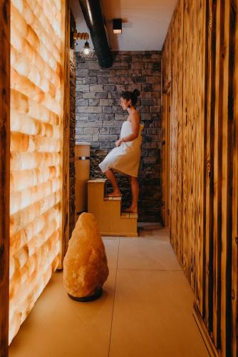 a woman in a dress sitting on a box in a room at Vila Roháčka - Luxusná Vila so súkromným wellness a bazénom in Habovka