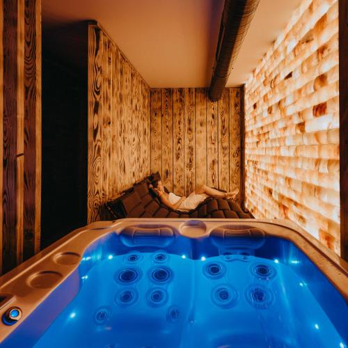 a jacuzzi tub in a room with a bed at Vila Roháčka - Luxusná Vila so súkromným wellness a bazénom in Habovka