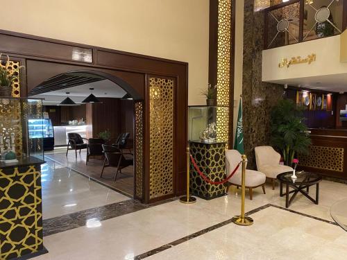 a lobby with a table and chairs in a building at Elite Park Hotel in Jeddah
