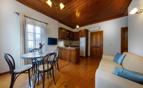 a living room with a table and chairs and a couch at Minyon Hotel in Antalya