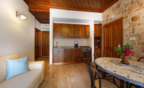 a kitchen with a table and a couch in a room at Minyon Hotel in Antalya