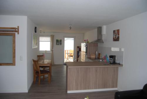 a kitchen and living room with a counter top at Haus Adria in Schleswig