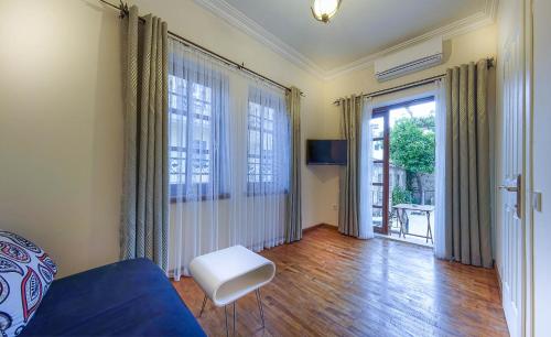 a living room with a blue couch and a window at Minyon Hotel in Antalya