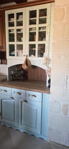a kitchen with blue cabinets and a counter at Villa Quercus in Alikampos