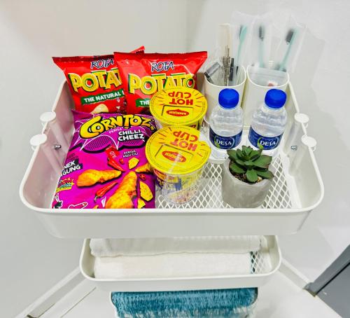 a refrigerator filled with snacks and water at Warisan HK GuestHouse in Jerantut