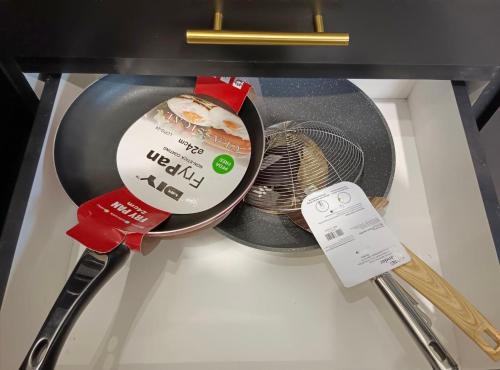 a container of food and a thermometer in a refrigerator at Warisan HK GuestHouse in Jerantut