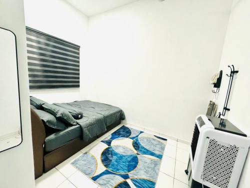 a bedroom with a bed and a tv in a room at Warisan HK GuestHouse in Jerantut