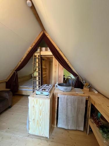 a kitchen in a tent with a sink in it at La Cabane de l'Orpailleur in Gravières