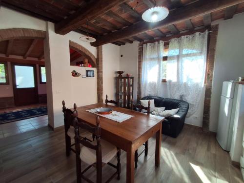 a living room with a wooden table and a couch at Fattoria Antognoni in Reggello