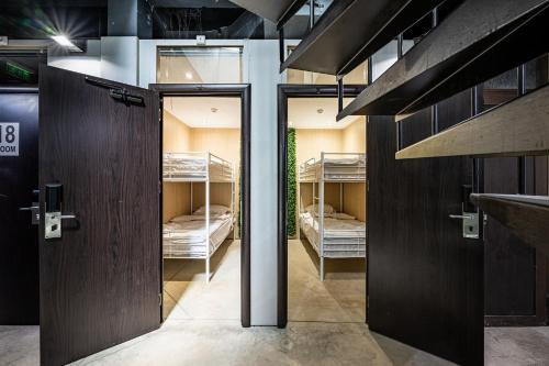 a room with two sets of doors with bunk beds at Heart of the city Hostel in Varna City