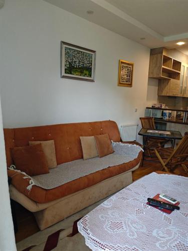 a living room with a couch and a table at Peaceful Family Stay Ilidza with Free Parking in Sarajevo
