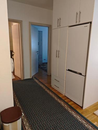 a kitchen with a white refrigerator and a hallway at Peaceful Family Stay Ilidza with Free Parking in Sarajevo