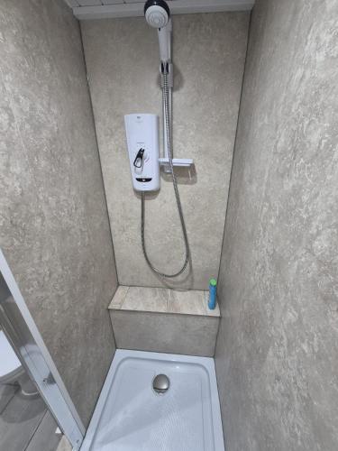 a bathroom with a shower with a toilet in it at Ulverston Town Centre Flat (2 Bedrooms) in Ulverston